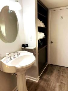 a bathroom with a sink and a mirror at Mae’s Cottage in the Clouds in Blue Ridge