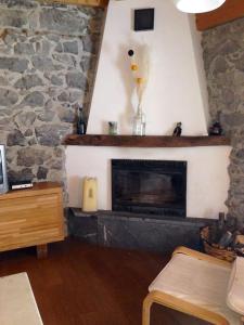 a living room with a fireplace with a stone wall at Casa con encanto in Arredondo