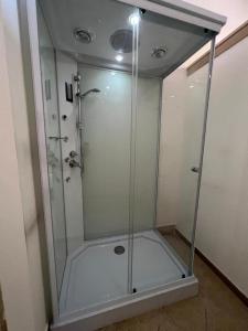 una doccia con cabina in vetro in bagno di wild rooms&house a Nettuno