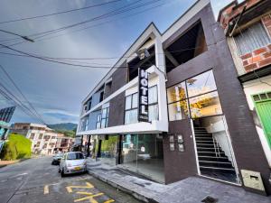 a building with a car parked in front of it at Hotel Boutique Veracruz termales in Santa Rosa de Cabal