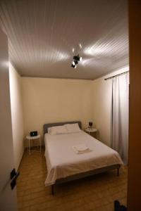 a bedroom with a bed and two side tables at Cozy Paradise in Preveza
