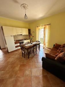 a kitchen and dining room with a table and a couch at Casa Fiorella in Fiano Romano