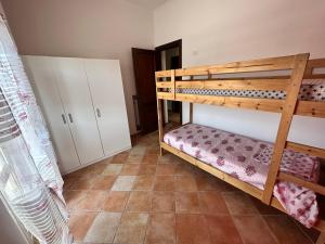 a room with two bunk beds and a tiled floor at Casa Fiorella in Fiano Romano