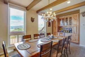 a dining room with a table and chairs and a large window at Dillon Vacation Rental Hot Tub and Beautiful Views! in Dillon