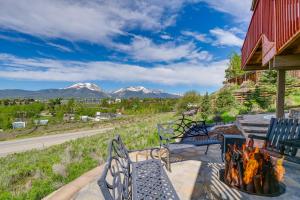 a fire pit on a patio with mountains in the background at Dillon Vacation Rental Hot Tub and Beautiful Views! in Dillon
