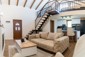 a living room with a couch and a staircase at Green Hill in Virpazar