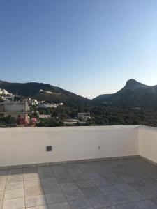 a white wall with a view of a mountain at Iliachtida apartments in Philotium