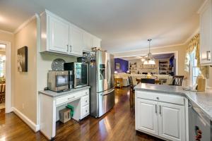 a kitchen with white cabinets and a refrigerator at Roomy Martinsville Vacation Rental with Private Deck in Martinsville