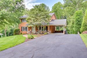 a home with a driveway leading to a house at Roomy Martinsville Vacation Rental with Private Deck in Martinsville