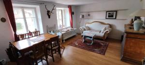 a living room with a table and a dining room at Apartment Ad Alta Obervellach in Obervellach