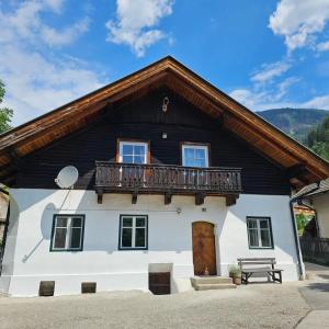 a house with a balcony on top of it at Apartment Ad Alta Obervellach in Obervellach