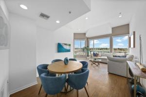 a living room with a table and chairs at Penthouse Waterfront In the Heart of MDR/Venice/SM in Los Angeles