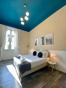 a bedroom with a large bed with blue ceilings at Dany House in Florence