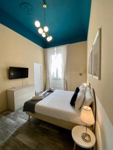 a bedroom with a large bed with a blue ceiling at Dany House in Florence