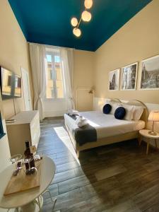 a bedroom with a large bed and a blue ceiling at Dany House in Florence