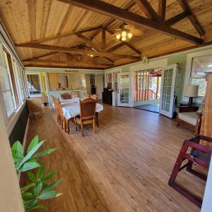 a large living room with a table and chairs at Kohala Village INN in Hawi