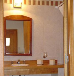 a bathroom with a sink and a mirror at ABROJITOS in Villa La Angostura