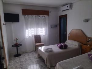 A bed or beds in a room at Hostal New York City