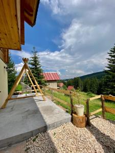 a backyard with a wooden fence and a porch at Magia di montagna in Žabljak