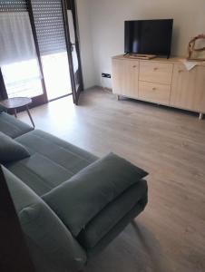 a living room with a couch and a flat screen tv at Appartamento Centro dei Venti in Montesilvano