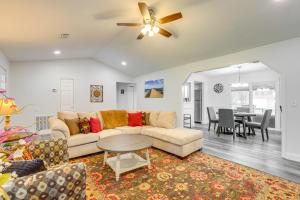 a living room with a couch and a table at Modern Ocala Oasis with Fire Pit and Gas Grill! in Marion Oaks