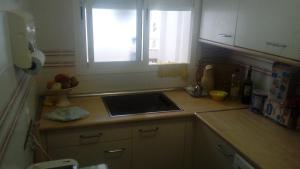 a kitchen counter with a sink and a window at Costa Portil - Arroyo de la Plata 5 in El Portil +2 photos