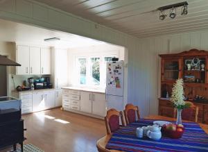 a kitchen with a table and a white refrigerator at room in family home in Gran