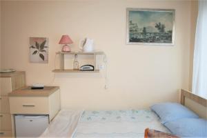 a bedroom with a bed and a desk and a picture at Arnina in Władysławowo