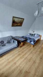 a living room with two beds and a couch at Willa Seba in Zakopane