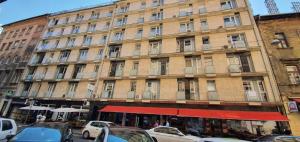 a large building with cars parked in front of it at HI Downtown Apartment A308 in Budapest