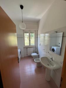 a bathroom with a sink and a toilet at Terrazza sul lago (CIR 017085-LNI-00027) in Iseo