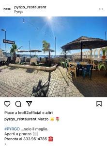 a picture of a restaurant with a table and an umbrella at Happy house in Civitavecchia