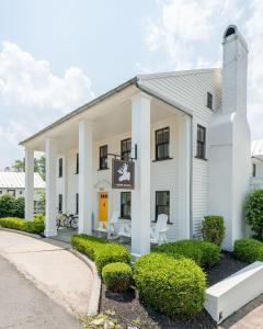 a white building with a sign in front of it at White Moose Inn in Washington, Virginia