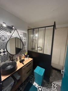 un baño con lavabo y espejo en Superbe T2 type loft proche Paris La Défense Arena et 30 min stade de France, en Puteaux