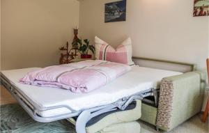 Una cama con una manta rosa encima. en Stunning Apartment In Wald Am Arlberg With Wifi en Wald am Arlberg