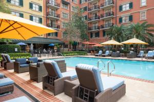 a pool at a hotel with chairs and umbrellas at Hotel Granduca Houston in Houston