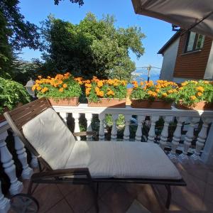 a chair sitting on a balcony with flowers at Villa Maria in Opatija