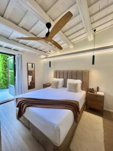 a bedroom with a large bed and a ceiling fan at Hotel Aatu - Adults Only in Peratallada