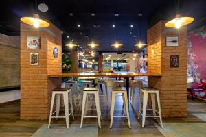 a bar with stools and a brick wall at GIO hotel Tama Cartagena in Cartagena de Indias