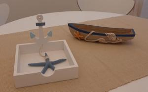 a box with a boat and a starfish in it at La Finestra su Santa Lucia in Monopoli +22 photos