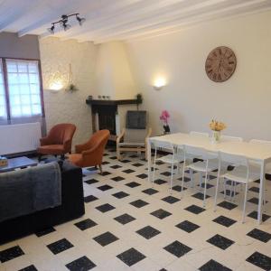 シャティオン・アン・ディオワにあるGîte du petit cheminのリビングルーム(テーブル、椅子、暖炉付)