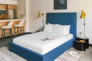 a bedroom with a large bed with a blue headboard at Sonder The Quincy in Washington, D.C.