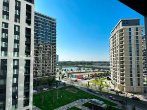 a view of two tall buildings and a river at SuprStay - Belgrade Waterfront Luxury Apartment in Belgrade