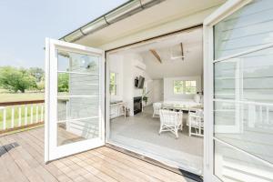 a sliding glass door leading to a patio with a table at White Moose Inn in Washington, Virginia