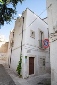 a white building with a sign on the side of it at Dimora del Castellano CASA SATURNO in Gioia del Colle