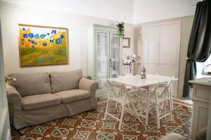 a living room with a couch and a table at Dimora del Castellano CASA SATURNO in Gioia del Colle