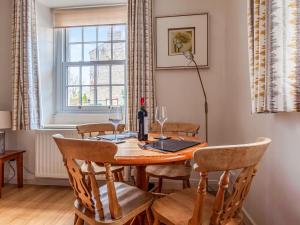 a dining room with a table with wine glasses at The Cottage in Stocksfield