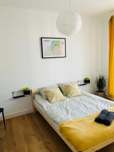 a bedroom with a bed and a pendant light at Apartament na Klasztornej in Wągrowiec