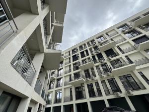 an apartment building with balconies and a car parked in front at Apartament Oxygen in Neptun +3 photos