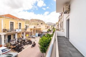 an apartment balcony with a view of a street at Theros Apartment in Palaiochora